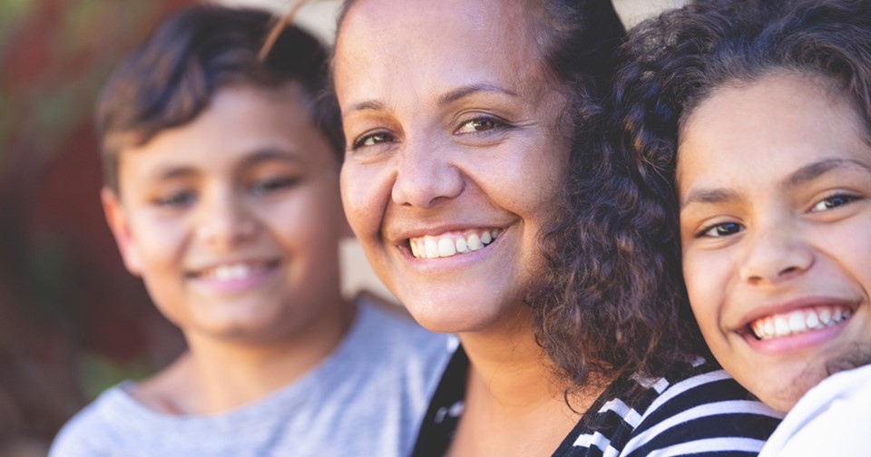 Aboriginal woman and her children smiling